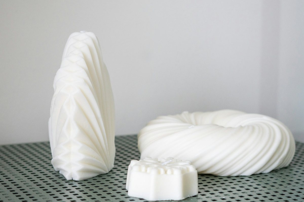 White 3D-printed master patterns on a bench