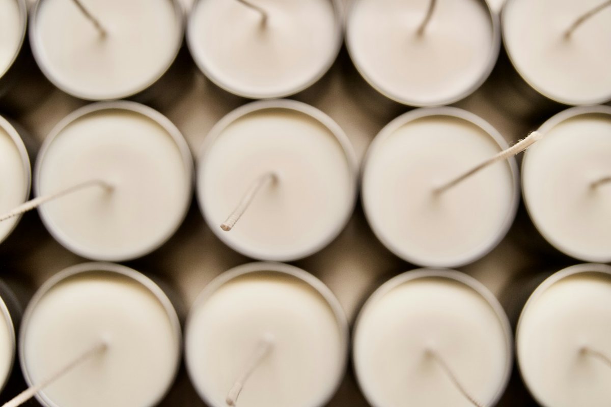 Rows of white container candles