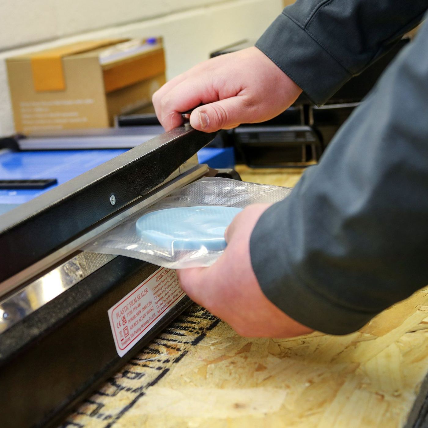 Heat sealing packaged parts.