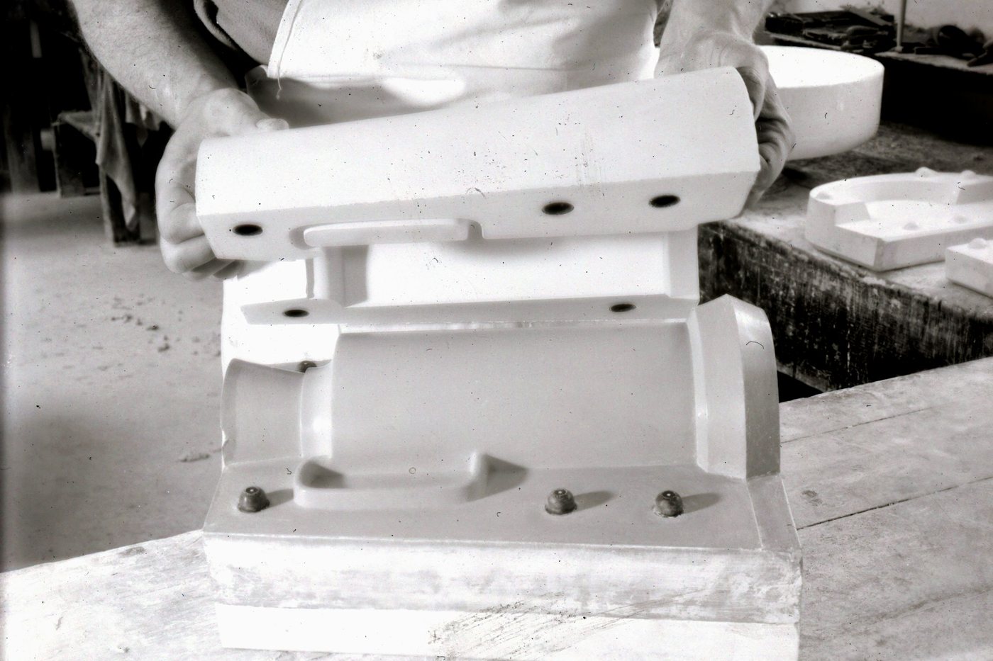 Hands finishing a prototype casting at the bench