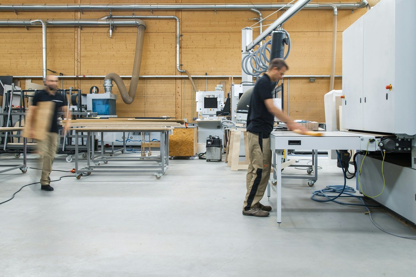 Bright, organised modern workshop with staff at work